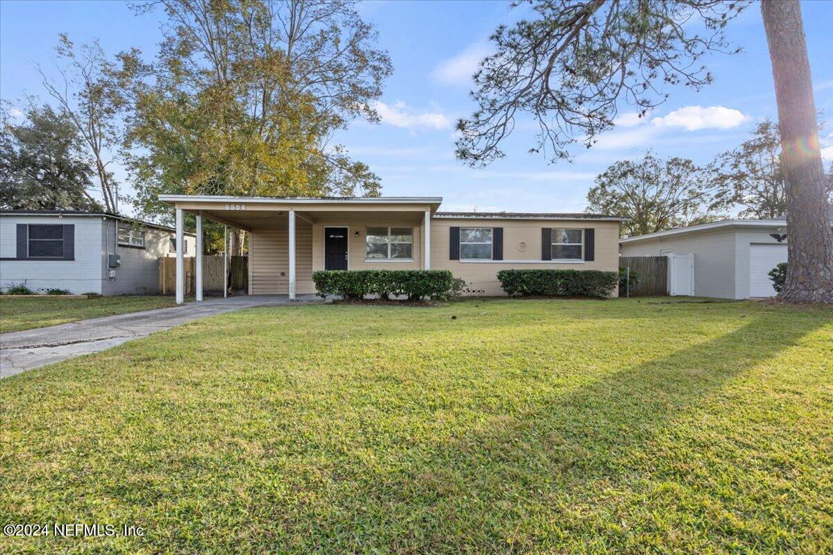 6584 Aires Road Jacksonville, FL 32244 - Photo 1 of 27 a front view of house with yard and green space