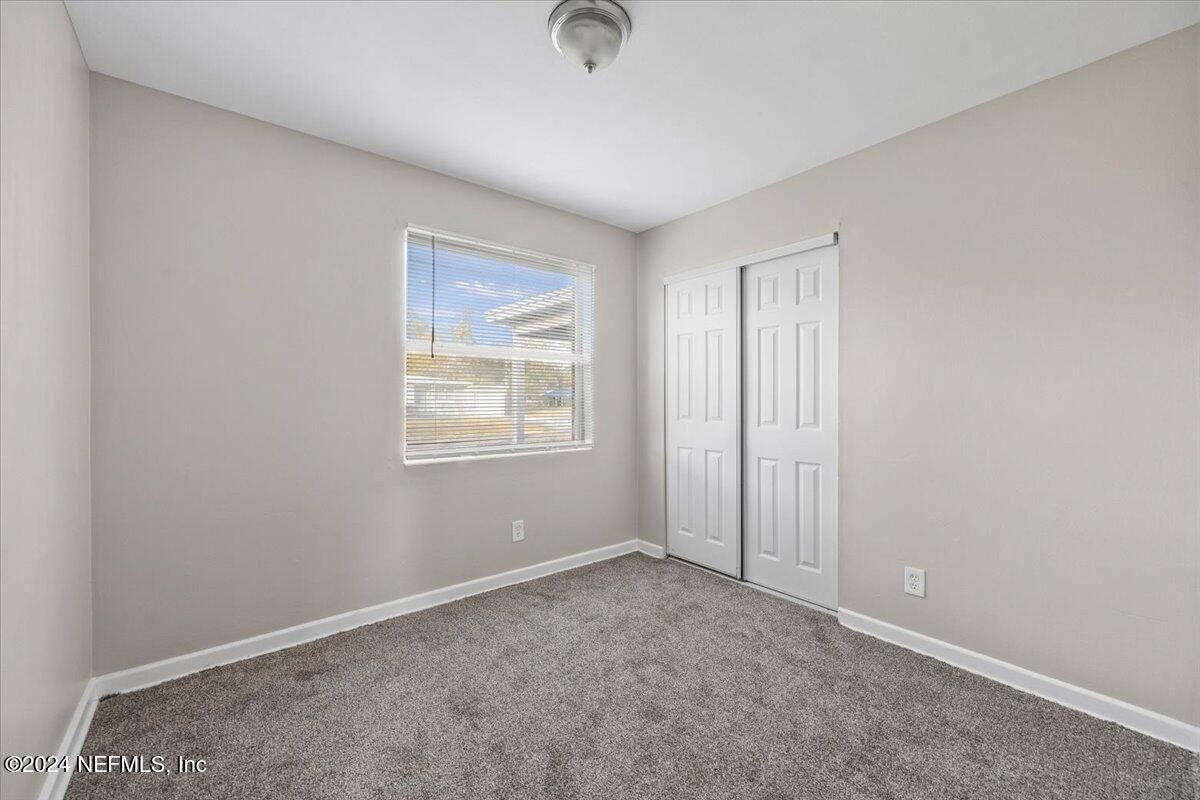 6584 Aires Road Jacksonville, FL 32244 - Photo 14 of 27 an empty room with windows and closet