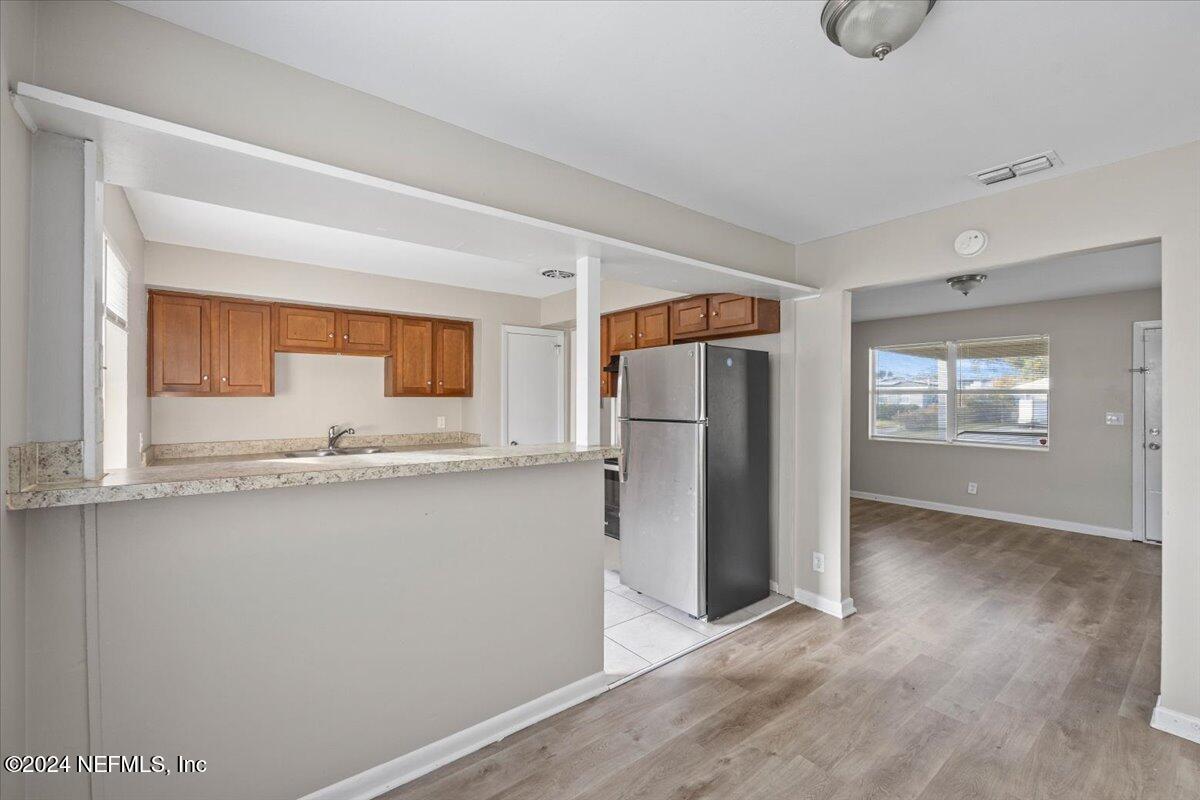 6584 Aires Road Jacksonville, FL 32244 - Photo 10 of 27 a kitchen with stainless steel appliances granite countertop a refrigerator and a sink