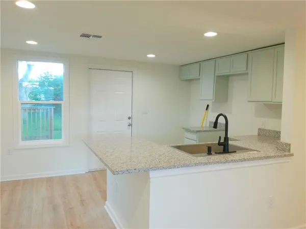 a kitchen with sink and window