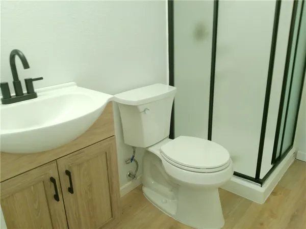 a white toilet sitting next to a sink