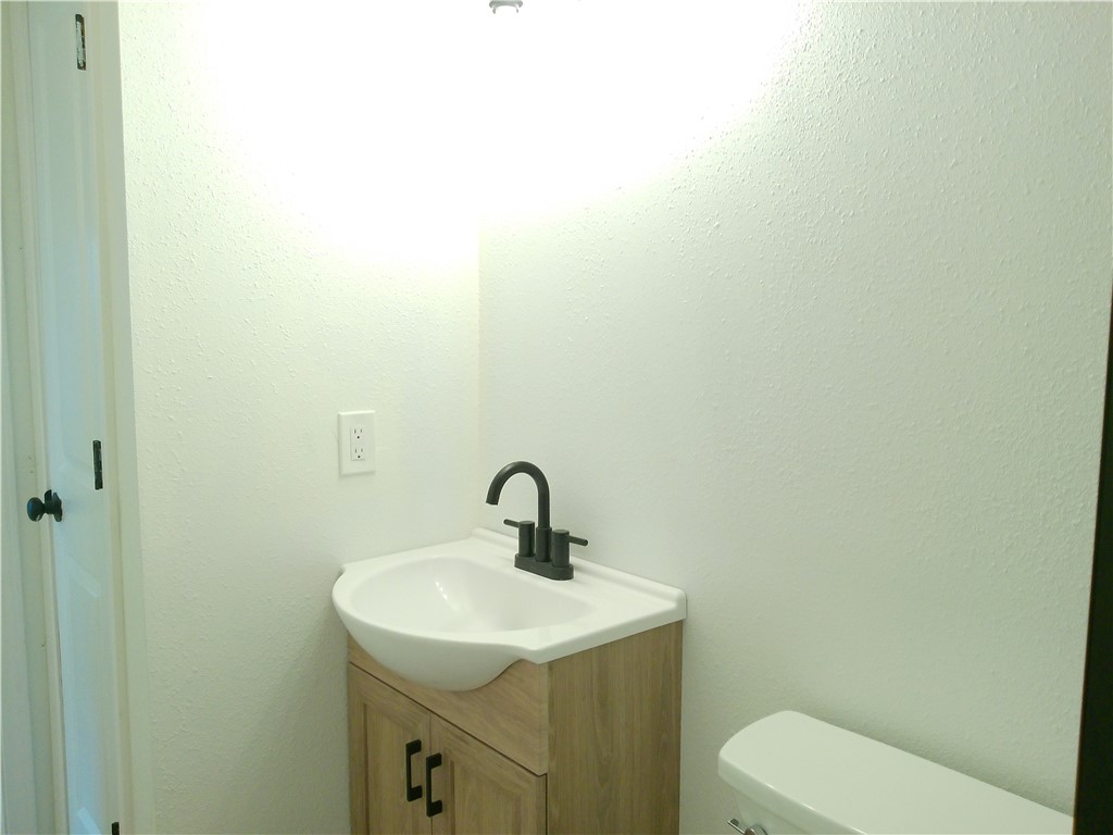 306 Allison Drive Gregory, TX 78359 - Photo 9 of 15 a bathroom with a toilet sink and mirror