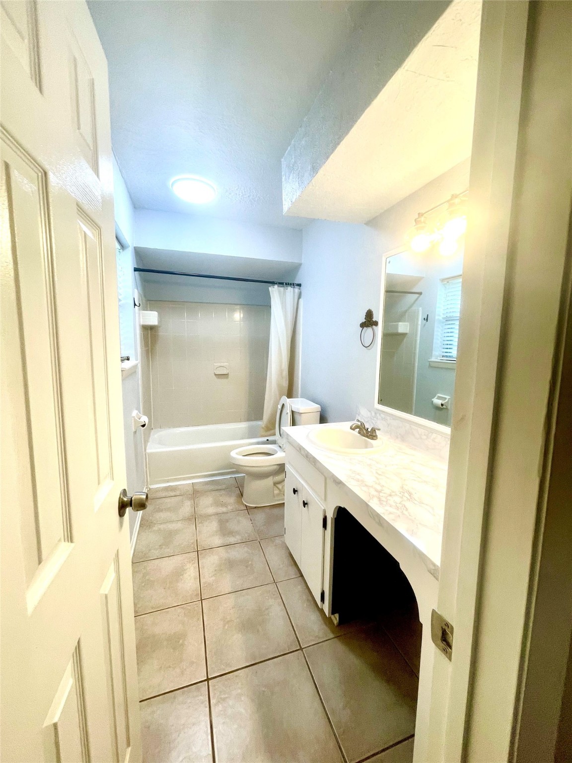 811 Tori Road Richmond, TX 77469 - Photo 11 of 14 a bathroom with a granite countertop sink a mirror and a bathtub