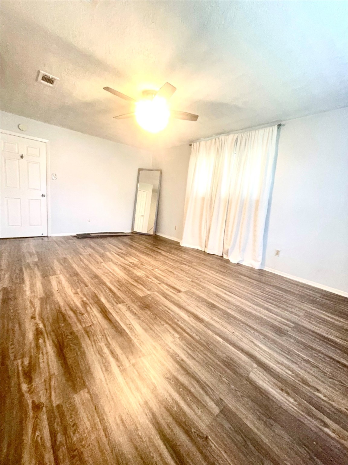 811 Tori Road Richmond, TX 77469 - Photo 12 of 14 a view of an empty room with wooden floor and a window