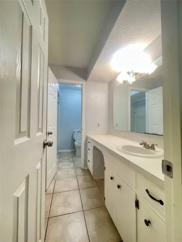 a bathroom with a double vanity sink mirror and
