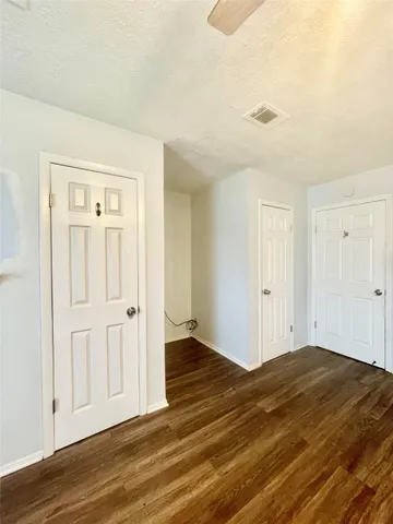 a view of an empty room and wooden floor