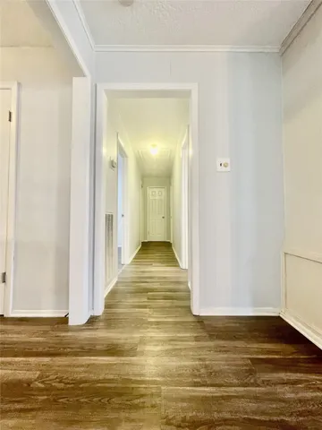 a view of room with window and wooden floor