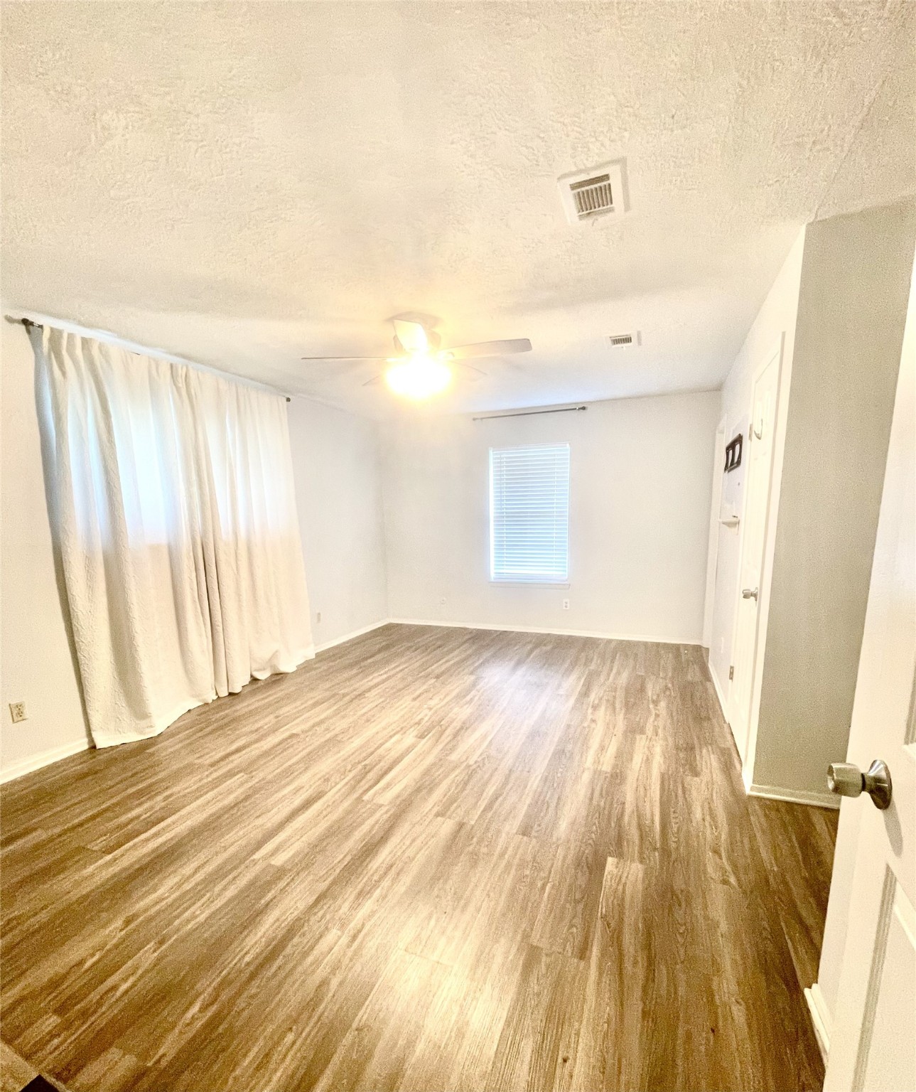 811 Tori Road Richmond, TX 77469 - Photo 10 of 14 wooden floor in an empty room with a window