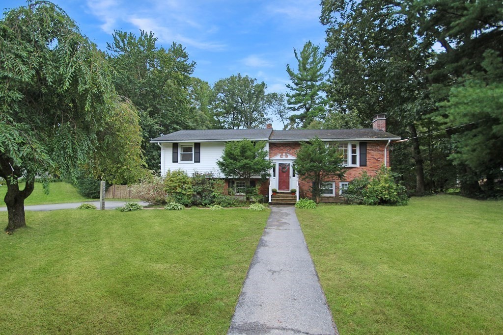12 Prairie Road Chelmsford, MA 01824 - Photo 1 of 33 a front view of a house with a yard and porch