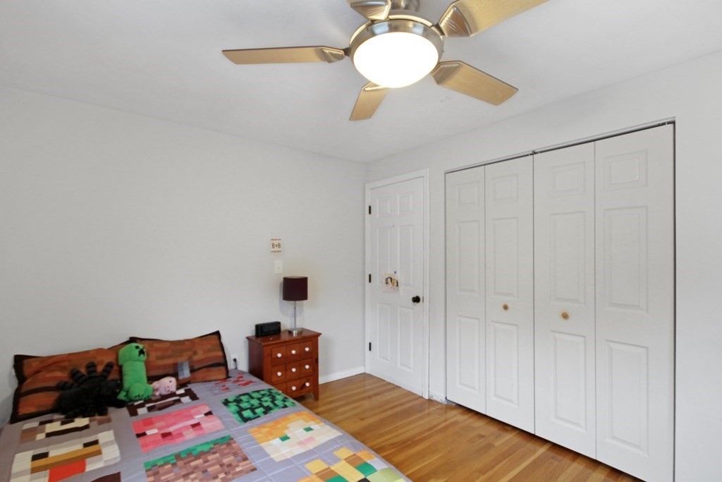 12 Prairie Road Chelmsford, MA 01824 - Photo 17 of 33 a bedroom with a bed and a chandelier