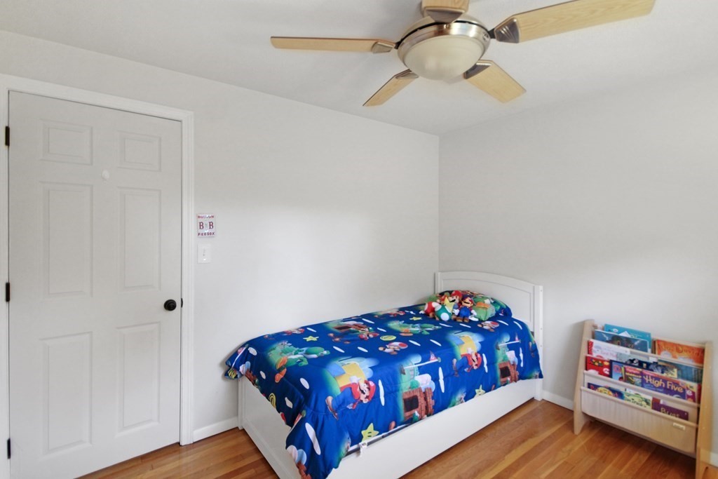 12 Prairie Road Chelmsford, MA 01824 - Photo 19 of 33 a bedroom with a bed and a chandelier