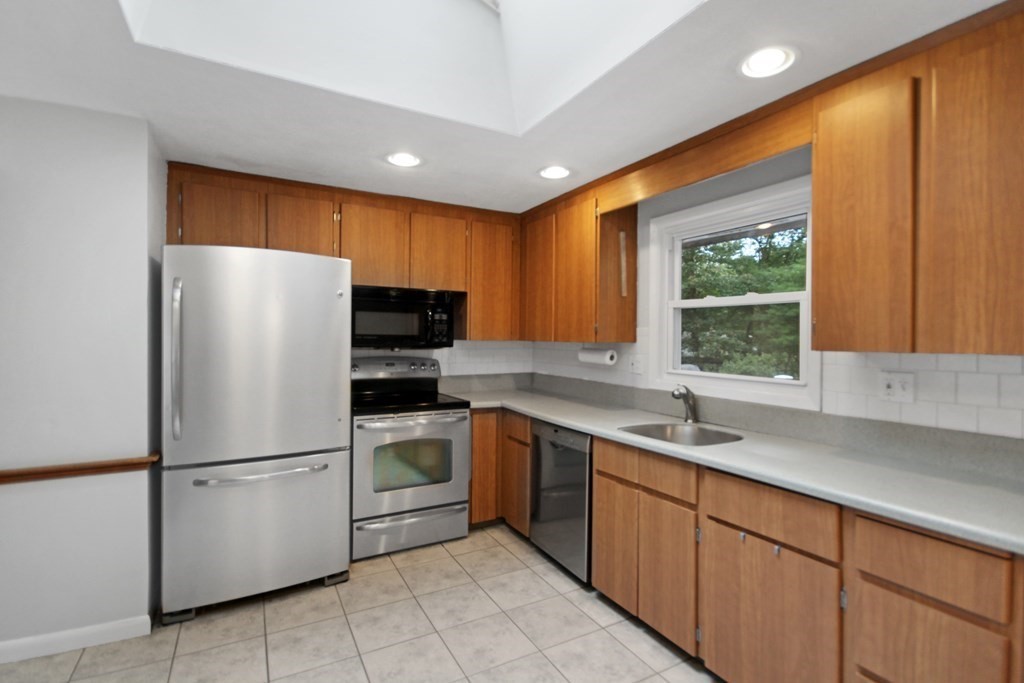 12 Prairie Road Chelmsford, MA 01824 - Photo 2 of 33 a kitchen with stainless steel appliances granite countertop a refrigerator sink and cabinets
