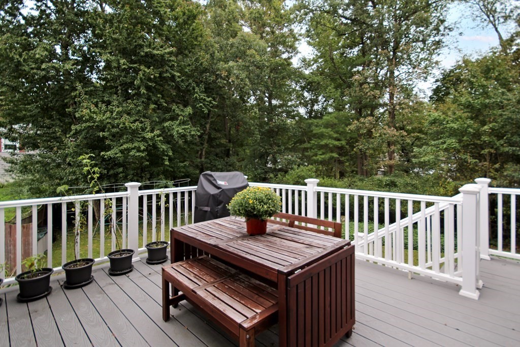 12 Prairie Road Chelmsford, MA 01824 - Photo 23 of 33 a view of a wooden deck with a bench