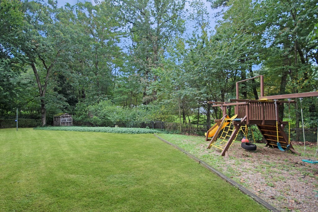 12 Prairie Road Chelmsford, MA 01824 - Photo 27 of 33 a view of a backyard with a slide and swing