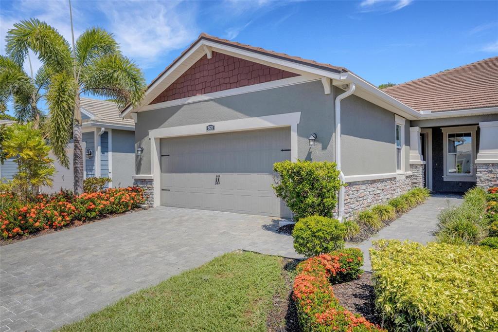 a view of a house with a yard and a garden