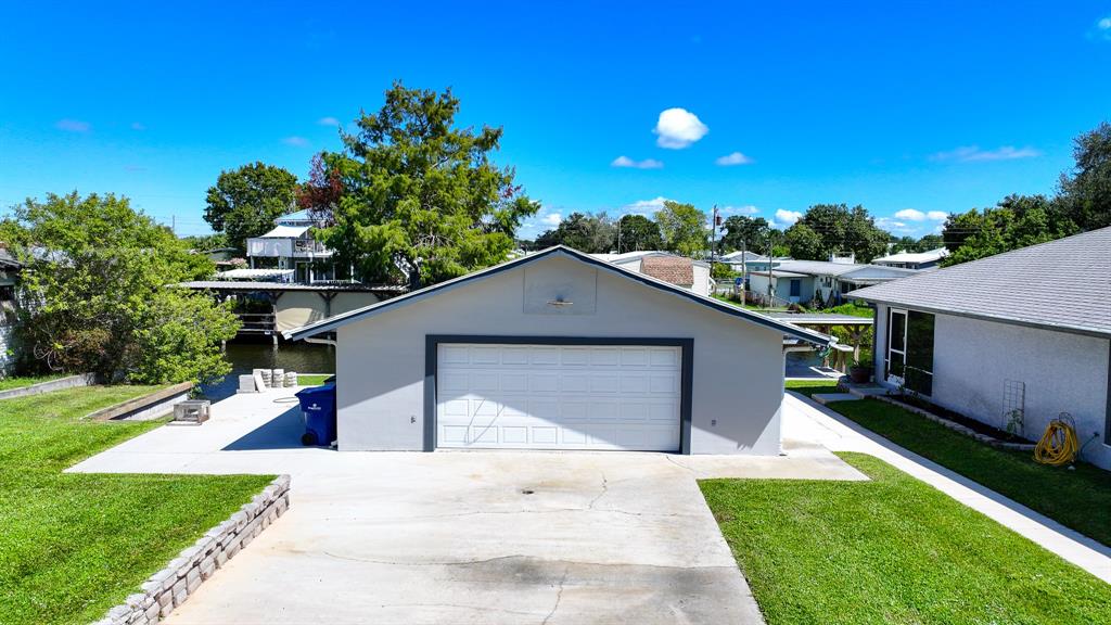 1069 9th Street Okeechobee, FL 34974 - Photo 14 of 48 a front view of a house with a yard and garage