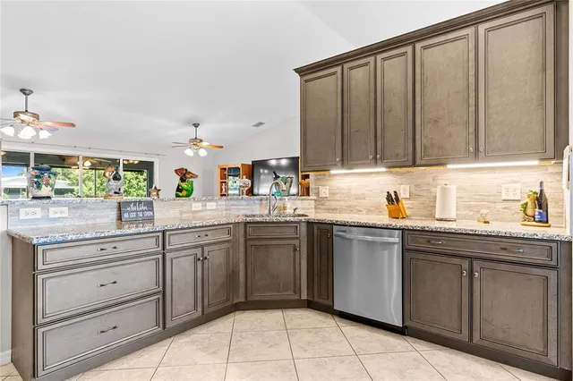 a kitchen with a sink window and cabinets