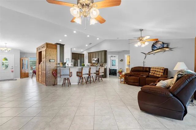 a living room with furniture and kitchen view