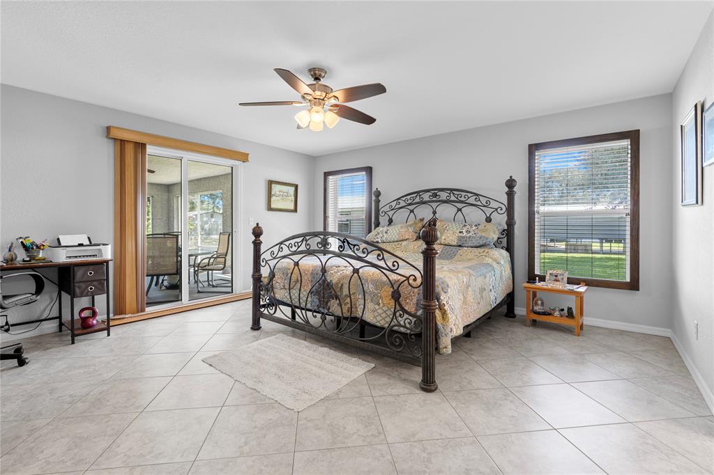 1069 9th Street Okeechobee, FL 34974 - Photo 26 of 48 a bedroom with a bed and a chandelier