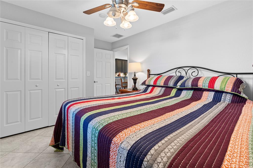 1069 9th Street Okeechobee, FL 34974 - Photo 30 of 48 a bedroom with bed and a chandelier