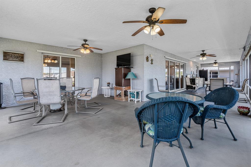 1069 9th Street Okeechobee, FL 34974 - Photo 35 of 48 a living room with furniture a chandelier fan and a window