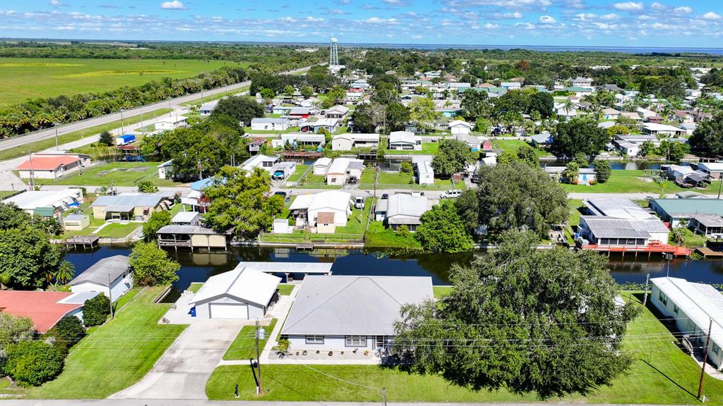 1069 9th Street Okeechobee, FL 34974 - Photo 39 of 48 an aerial view of residential houses with outdoor space and trees