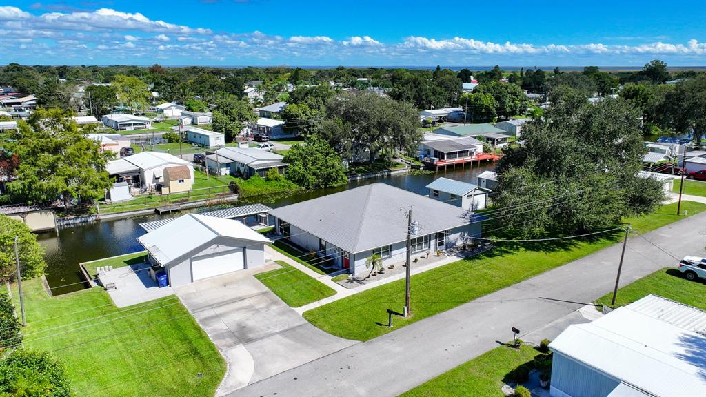 1069 9th Street Okeechobee, FL 34974 - Photo 40 of 48 an aerial view of a house with a garden and swimming pool