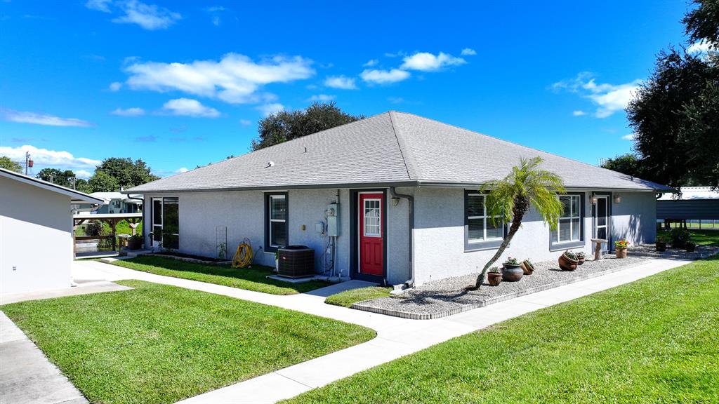 1069 9th Street Okeechobee, FL 34974 - Photo 4 of 48 a view of a house with backyard porch and sitting area