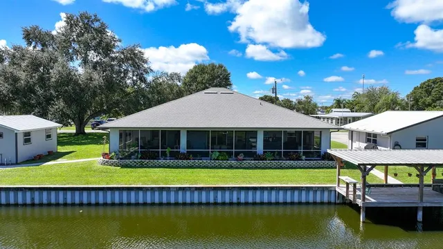 a view of a house with swimming pool and porch with furniture