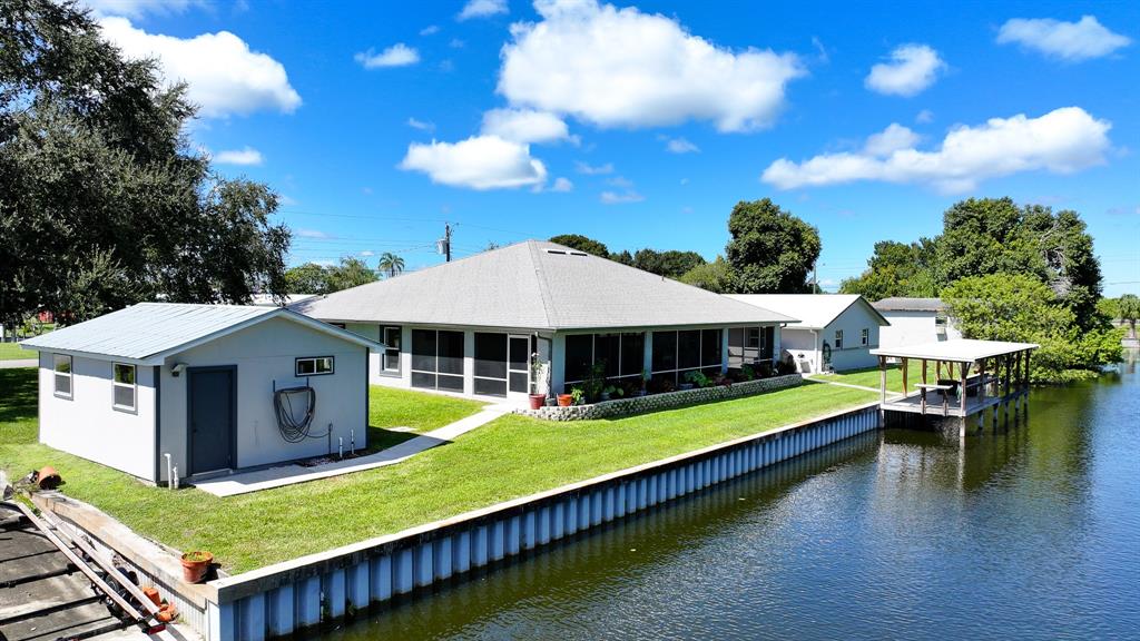 1069 9th Street Okeechobee, FL 34974 - Photo 7 of 48 a view of a house with pool and chairs