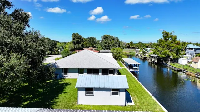 a aerial view of a house with swimming pool lake view and mountain view