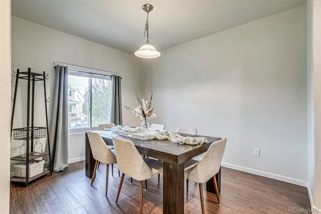 a view of a dining room with furniture window and wooden floor