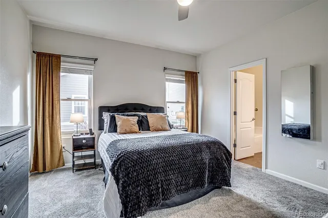 a bedroom with a bed and a mirror