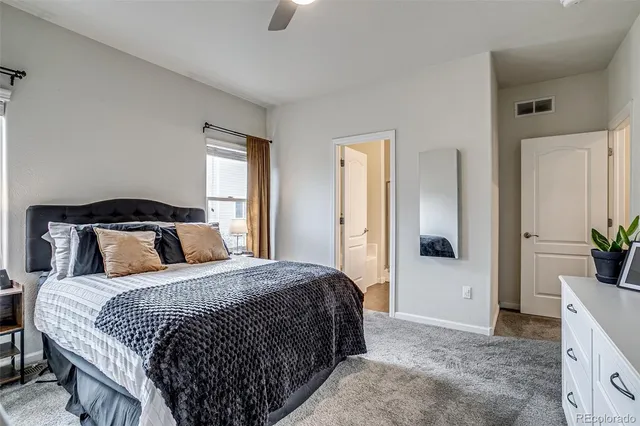 a bedroom with a bed and a potted plant
