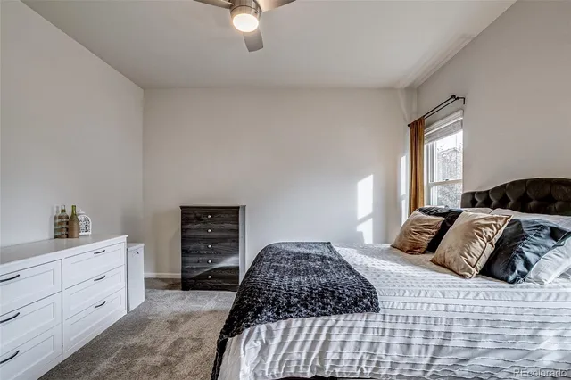 a bedroom with a bed and a dresser