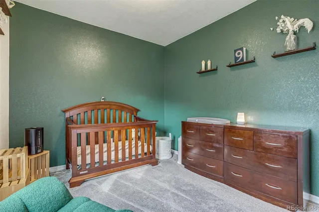 a view of a livingroom with a baby crib