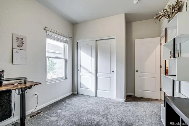 a view of kitchen with furniture and refrigerator