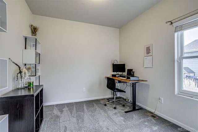 a view of a workspace with furniture