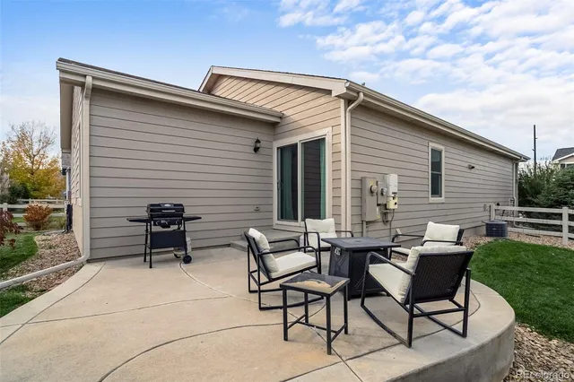 a backyard of a house with outdoor seating