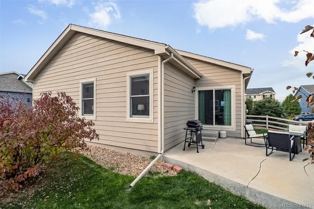 a backyard of a house with table and chairs