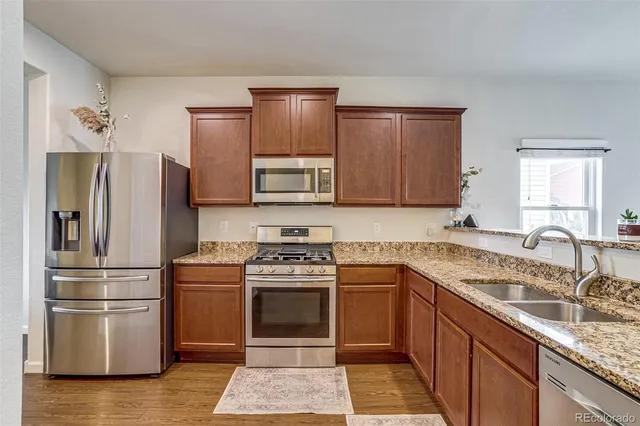 a kitchen with a sink stove and refrigerator
