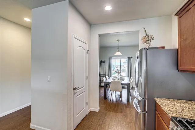 a view of a hallway with furniture and wooden floor