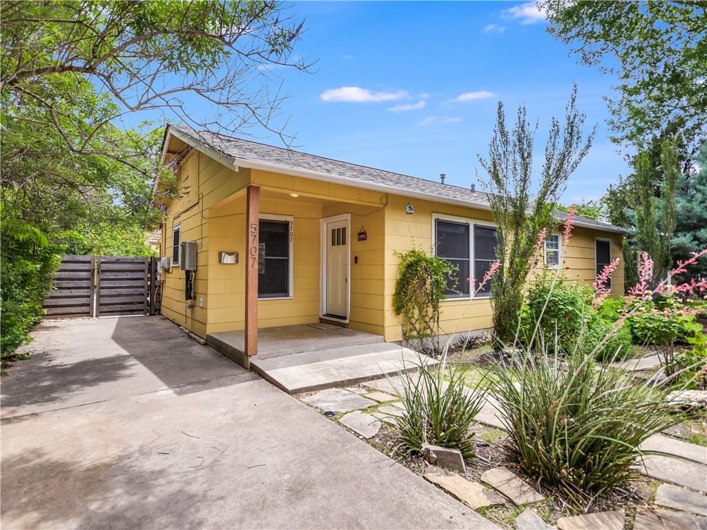 a view of a house with many windows next to a road