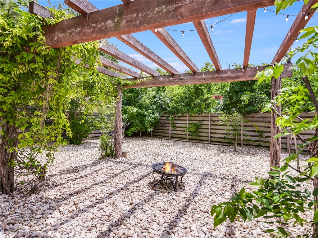 5707 Avenue F Austin, TX 78752 - Photo 12 of 17 a backyard of a house with large trees and plants