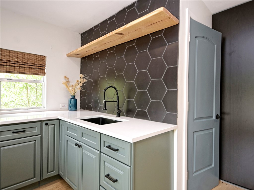 5707 Avenue F Austin, TX 78752 - Photo 15 of 17 a kitchen with a sink and cabinets