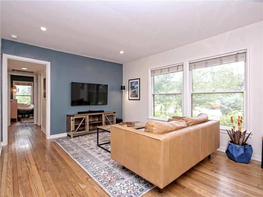 5707 Avenue F Austin, TX 78752 - Photo 2 of 17 a living room with furniture and a flat screen tv