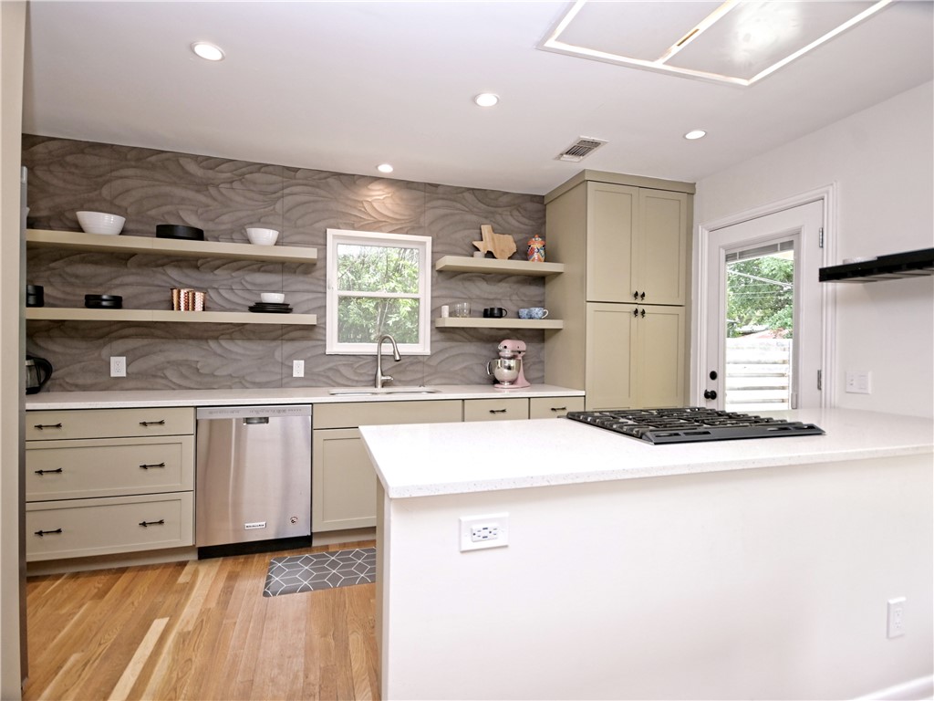 5707 Avenue F Austin, TX 78752 - Photo 3 of 17 a kitchen with kitchen island sink stove and cabinets
