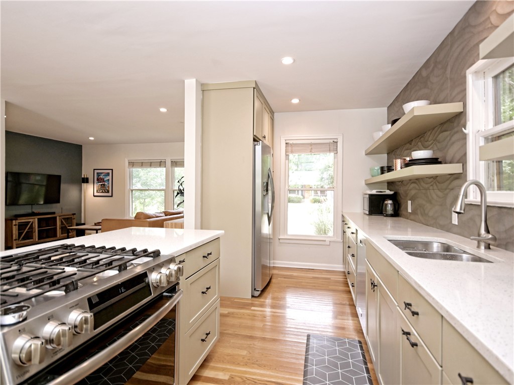 5707 Avenue F Austin, TX 78752 - Photo 4 of 17 a kitchen with a stove and a sink