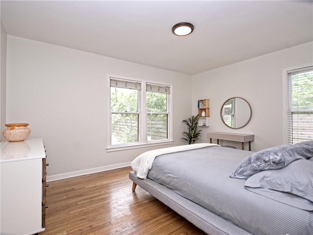 5707 Avenue F Austin, TX 78752 - Photo 7 of 17 a bed sitting in a bedroom next to a window