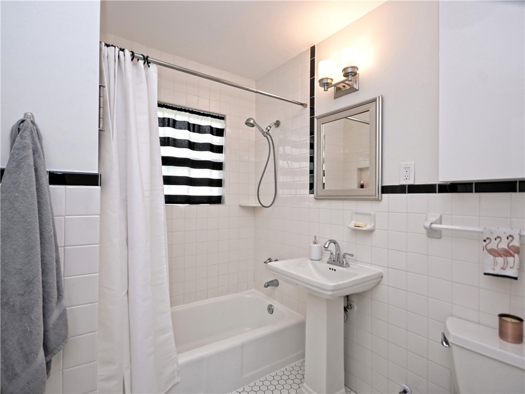 5707 Avenue F Austin, TX 78752 - Photo 9 of 17 a bathroom with a sink a toilet and shower
